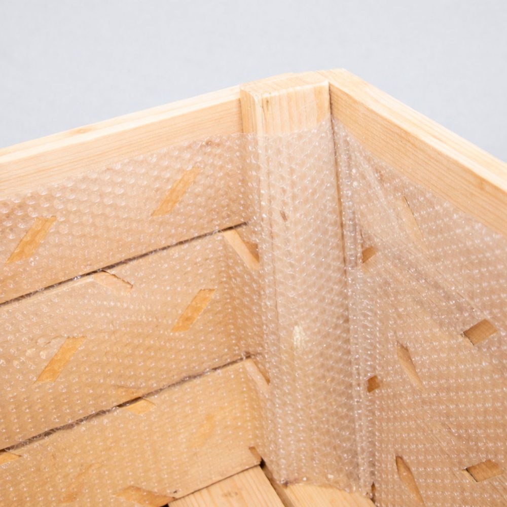 Lámina de burbuja para palot de fruta, protección interior contra golpes y daños en el transporte.